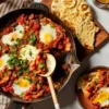 Shakshuka (Tomato-Pepper Stew with Poached Eggs and Harissa)