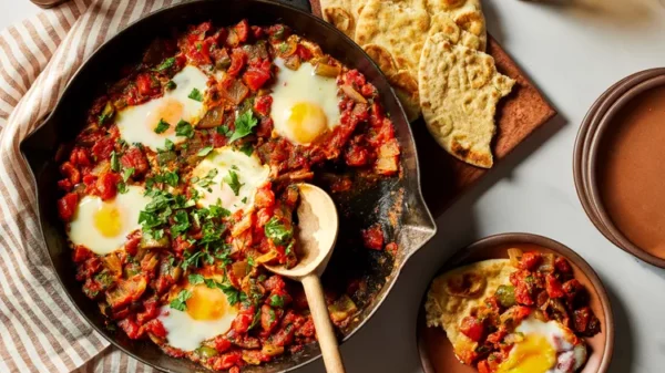 Shakshuka (Tomato-Pepper Stew with Poached Eggs and Harissa)